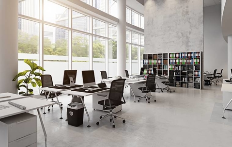 huge office room with multiple desks and book shelf